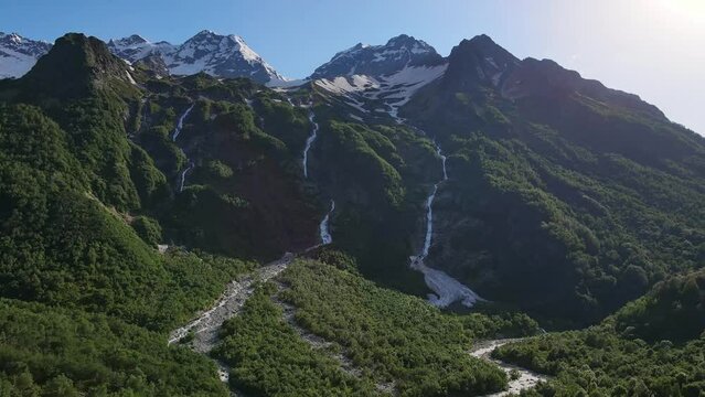 Taimazi waterfalls flowing down from the slope of Taimazi mountain. Beautiful valley of the Tanadon Gorge. Caucasus mountains. Digoria, North Ossetia-Alania, Russia. Drone view