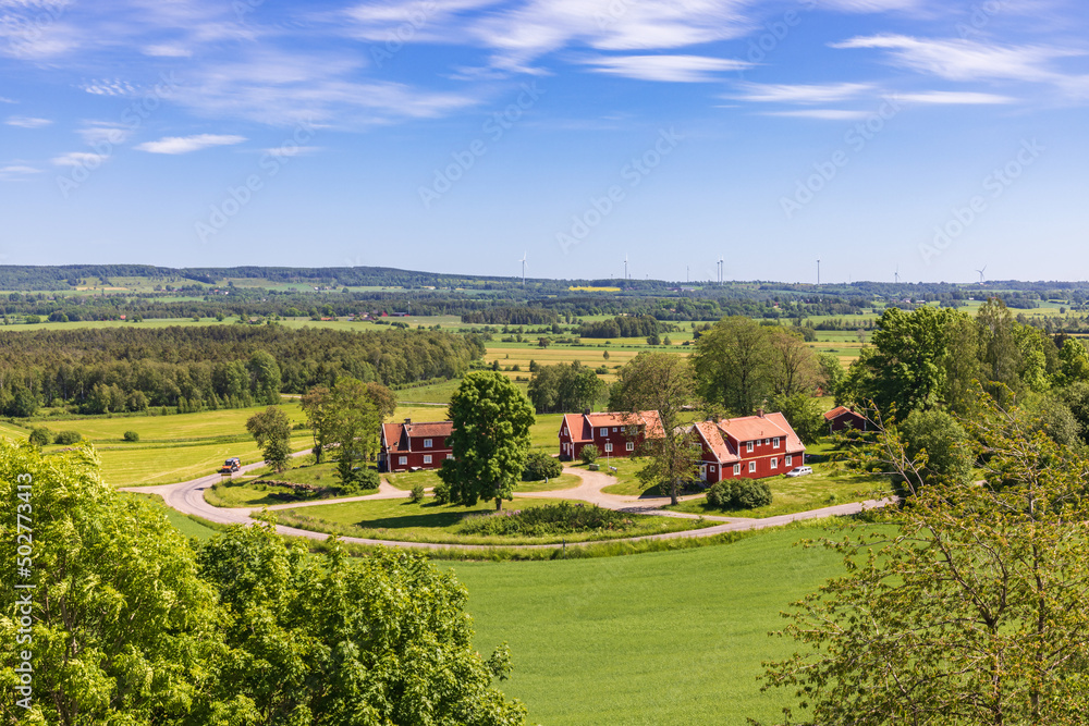 Canvas Prints Scenic view at a rural landscape with red houses by a road