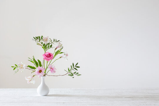 Pink And White Flowers In Vase On White Background