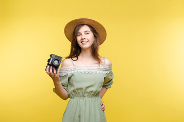 Young girl in straw hat and glasses keeping camera