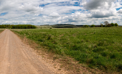 Fototapeta na wymiar A scenic panoramic view toward a tump, Sidbury Hill on Salisbury Plain