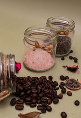 Handcrafted cosmetic concept. Natural ingredients for beauty product coffee, lavender, salt in glass containers on olive background. Close up, selective focus
