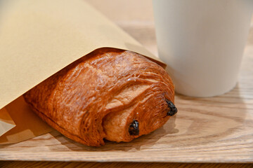 Bread and coffee on wood grain colored tabletop