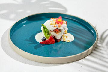 Carrot cake with cream cheese and berries on ceramic plate. Elegant dessert - carrot pie on white...