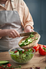 Close up woman making healthy salat at home