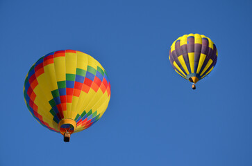 colorful image two bright balloons in the blue sky