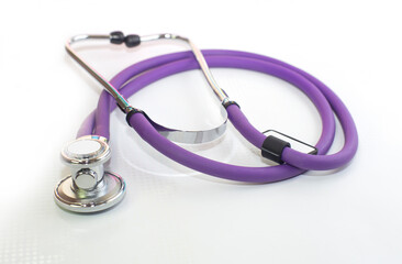 medical stethoscope purple color, on a white background