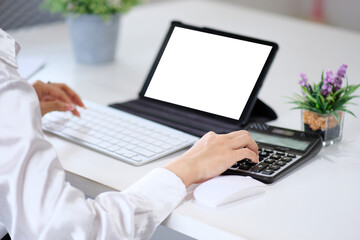 Woman accountant using calculator and laptop computer in office, businessman working at home, finance and accounting concept.