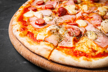 hot delicious traditional italian pizza on a dark stone background
