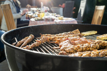 Cooking food on the barbecue, outdoor. Delicious meat on sticks and cheese on the grill, in the...