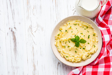 fresh tasty mashed potatoes on a white wooden rustic background