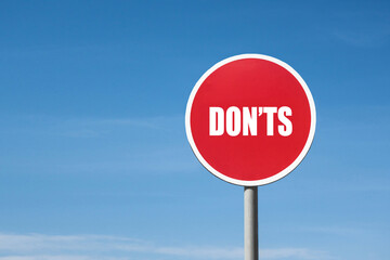 'Dont's' sign in red frame. Blue sky is on background