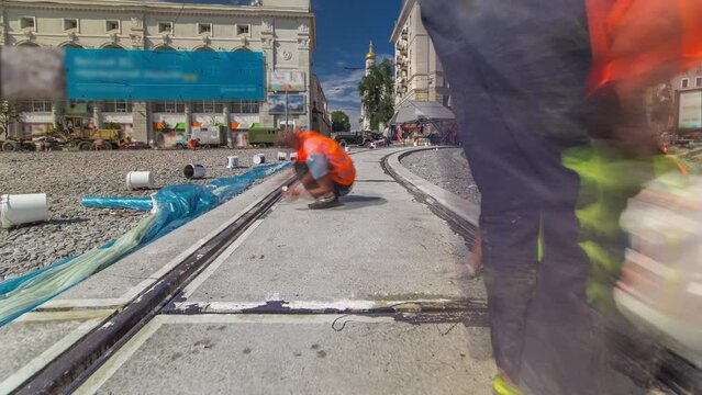 Tram rails at the final stage of their installation and integration into concrete plates on the road panoramic timelapse. Filling by liquid resin for reduction of vibration and noice. The process of