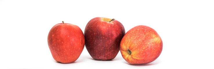 Three juicy ripe red apples isolated on white background. Healthy food.