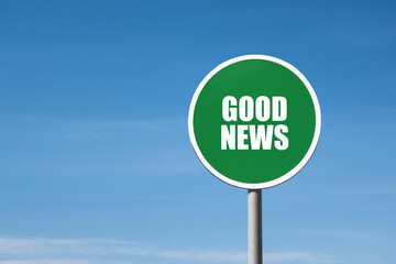 'Good news' sign in green round frame. Clear blue sky is on background