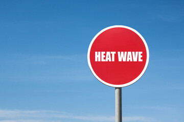 'Heat wave' sign in red round frame. Clear sky is on background