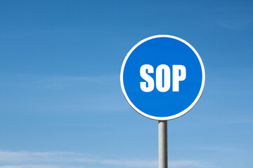 'SOP' sign in blue round frame. Clear sky is on background