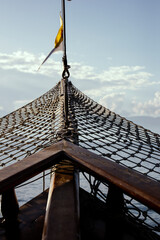The stem, front, bow of the ship, boat. Old ship, Aesthetics of pirates, navigations. Flag and net...