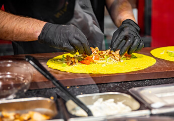 process of preparing traditional Turkish fast food - grilled meat or shawarma or kebab. chef hand cooking food
