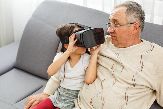 grandfather and granddaughter with virtual glasses