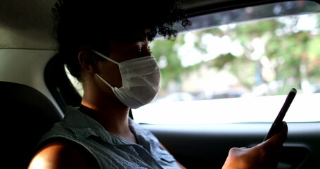 Passenger african descent girl riding taxi wearing virus prevention mask