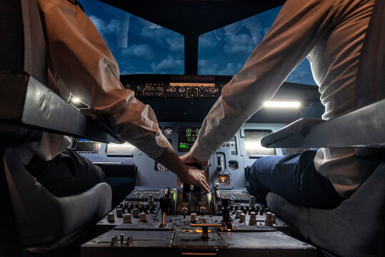pilots in a cockpit in an airplane