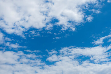 Naklejka na ściany i meble Blue sky with white clouds. Heavenly landscape background.