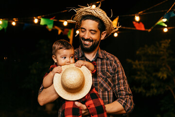 Portrait of father and baby son during the typical Brazilian Festa Junina