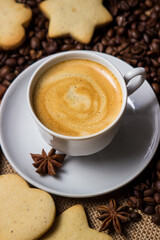 Espresso coffee on the background of coffee beans. A cup of coffee with cinnamon. invigorating drink