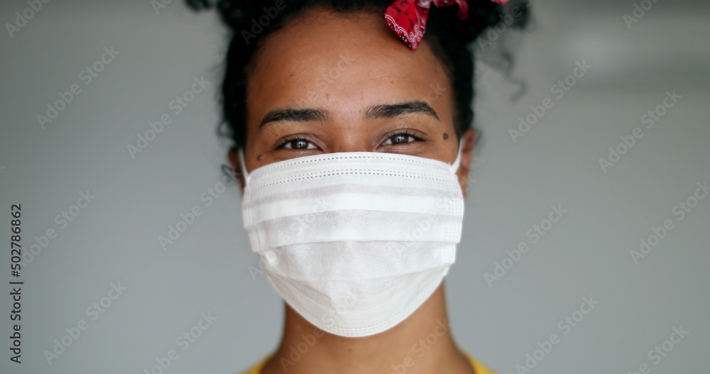 Wall mural African american woman putting covid-19 face mask prevention against disease