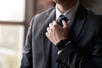 Businessman adjusting his necktie. Lawyer in suit. Legal law, advice and justice concept.