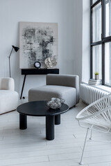modern minimalistic interior design of light bright monochrome room with black and white furniture,...