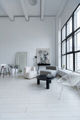 modern minimalistic interior design of light bright monochrome room with black and white furniture, clean white walls and huge windows