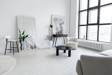 modern minimalistic interior design of light bright monochrome room with black and white furniture, clean white walls and huge windows