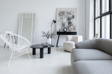 modern minimalistic interior design of light bright monochrome room with black and white furniture, clean white walls and huge windows