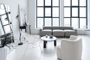 modern minimalistic interior design of light bright monochrome room with black and white furniture, clean white walls and huge windows