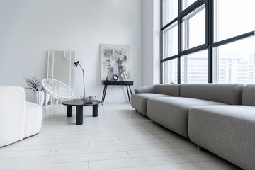 modern minimalistic interior design of light bright monochrome room with black and white furniture, clean white walls and huge windows