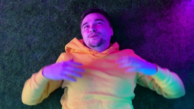 Man high after consuming psychodelics, having good trip with colorful lights