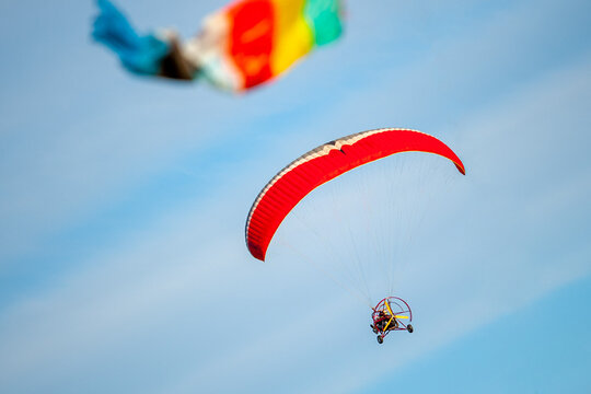 Paragliding flight against the blue sky, the view when turning is not along the horizon.