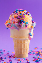 A Scoop of Unicorn Colored Ice Cream in a Cone