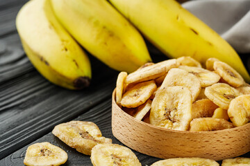 delicious dried banana on a black wooden rustic background