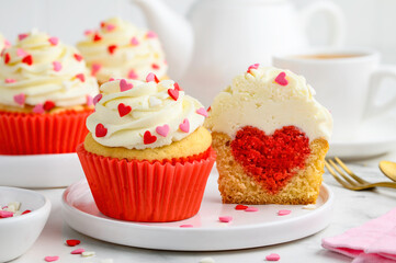 Festive cupcakes with a heart inside for Valentine's Day decorated with sprinkles with hearts....