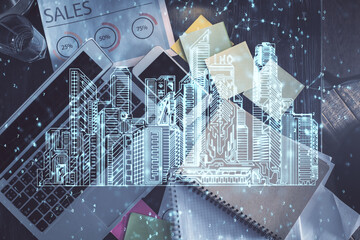 City drawing over computer on the desktop background. Top view. Double exposure. Smart home concept.