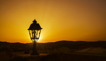 Street lamp against the backdrop of a golden sunset
