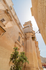 Sharp angled, geometric old fortress buildings with a clear sky above in old Malta Capital Mdina