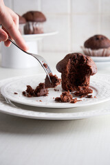 unrecognizable woman's hand eating muffins with a fork. Close Up. Breakfast time