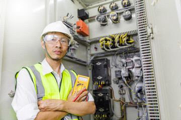 Electrical engineer holding digital multimeter, Electrical engineer is inspecting the electrical...