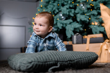 Naklejka premium Toddler kid boy on the background of the Christmas tree. High quality photo