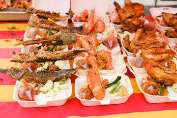 Selective focus picture of shrimp and fish sold at the food stall.