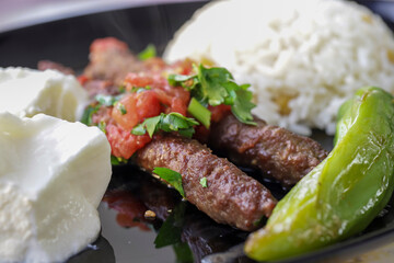 Delicious Turkish Traditional Manisa Kebap, Tire Kofte serving on metal plate